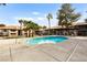 Inviting community pool with palm trees and comfortable seating in a well-maintained environment at 2606 S Durango Dr # 276, Las Vegas, NV 89117