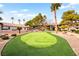 Well-maintained putting green surrounded by lush landscaping with palm trees and shrubbery at 2606 S Durango Dr # 276, Las Vegas, NV 89117