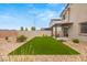 Well maintained backyard with a patio, artificial grass, desert landscaping and a pergola at 2624 Stanhurst Ave, North Las Vegas, NV 89081