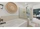 Elegant bathroom featuring a soaking tub, glass shower, and modern accents at 2624 Stanhurst Ave, North Las Vegas, NV 89081