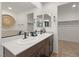 Modern bathroom with dual sinks, dark wood cabinets, and stylish fixtures at 2624 Stanhurst Ave, North Las Vegas, NV 89081