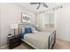 Cozy bedroom with a comfortable bed, ceiling fan, carpet and a well-lit window with bright, white curtains at 2624 Stanhurst Ave, North Las Vegas, NV 89081