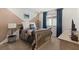 Stylish bedroom with unique, diagonally painted wall, a comfortable bed, and natural light at 2624 Stanhurst Ave, North Las Vegas, NV 89081