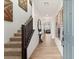 Inviting foyer with wood-look tile flooring, staircase, and decorative wall art at 2624 Stanhurst Ave, North Las Vegas, NV 89081