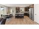 Modern kitchen featuring dark cabinets, stainless steel appliances, and a center island with seating at 2624 Stanhurst Ave, North Las Vegas, NV 89081