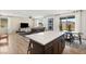 Bright open-concept living area with a modern kitchen island and sliding doors to the outdoor space at 2624 Stanhurst Ave, North Las Vegas, NV 89081