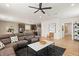 Open-concept living room with a modern ceiling fan, stylish decor, and hardwood floors at 2624 Stanhurst Ave, North Las Vegas, NV 89081