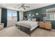 Inviting main bedroom with elegant green accent wall, soft carpet, and large windows at 2624 Stanhurst Ave, North Las Vegas, NV 89081