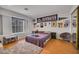Cozy bedroom with wood floors, a Cowboys-themed wall, a rug, and comfortable furniture at 271 Sunshine Springs Ct, Henderson, NV 89014