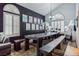 Open dining room with a long table, decor, two large windows, and modern lighting fixtures at 271 Sunshine Springs Ct, Henderson, NV 89014