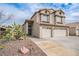 Two-story home featuring desert landscaping and a spacious two-car garage, offering curb appeal at 271 Sunshine Springs Ct, Henderson, NV 89014