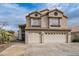 Charming two-story home with a tile roof and spacious two-car garage, complemented by desert landscaping at 271 Sunshine Springs Ct, Henderson, NV 89014