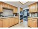 Well-lit kitchen featuring wooden cabinets, stone countertops, and modern stainless steel appliances at 271 Sunshine Springs Ct, Henderson, NV 89014