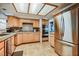 Well-equipped kitchen with stainless steel appliances, light wood cabinetry, and a skylight for natural light at 271 Sunshine Springs Ct, Henderson, NV 89014