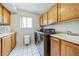 Efficient laundry room featuring a modern washer and dryer, sink, and cabinet storage at 271 Sunshine Springs Ct, Henderson, NV 89014