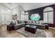Inviting living room with high ceilings, stylish decor, and tile flooring, perfect for relaxation at 271 Sunshine Springs Ct, Henderson, NV 89014