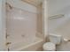 Bathroom with a bathtub, tiled walls, and a toilet at 2851 S Valley View Blvd # 1161, Las Vegas, NV 89102