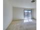 Bedroom with a glass sliding door, light carpet, and bright natural light at 2851 S Valley View Blvd # 1161, Las Vegas, NV 89102