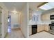 Hallway view leading to a bright kitchen with stainless steel appliances at 2851 S Valley View Blvd # 1161, Las Vegas, NV 89102