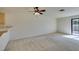 Carpeted living room with a ceiling fan and sliding glass door to the outside at 2851 S Valley View Blvd # 1161, Las Vegas, NV 89102