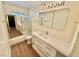 Bathroom features a modern vanity with double drawers, sleek mirror, and a glass-enclosed shower at 3037 Holly Hill Ave, Las Vegas, NV 89104