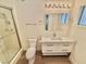 Bathroom features a modern vanity, sleek mirror, and a glass-enclosed shower at 3037 Holly Hill Ave, Las Vegas, NV 89104