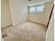 Bedroom featuring neutral carpet, white walls, a window with blinds, and closet at 3037 Holly Hill Ave, Las Vegas, NV 89104