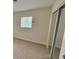 Bedroom featuring neutral carpet, white walls, a window with blinds, and closet at 3037 Holly Hill Ave, Las Vegas, NV 89104