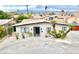 Home exterior featuring xeriscaping, a mature palm tree, a long driveway, and mountain views at 3037 Holly Hill Ave, Las Vegas, NV 89104