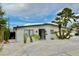 Charming single-story home featuring a desert landscaped yard, palm trees, and a concrete driveway at 3037 Holly Hill Ave, Las Vegas, NV 89104