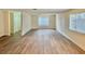 Spacious living room featuring wood flooring and natural light from the windows creating a bright and inviting space at 3037 Holly Hill Ave, Las Vegas, NV 89104