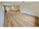 Large living area featuring wood flooring, neutral walls, and windows offering natural light and an airy atmosphere at 3037 Holly Hill Ave, Las Vegas, NV 89104