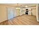 Open-concept living and kitchen area with new wood flooring and natural light from large sliding glass doors at 3037 Holly Hill Ave, Las Vegas, NV 89104