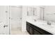 Bright bathroom featuring double sinks, dark cabinets, and a shower and tub combo at 3136 Mossfield Ave, Henderson, NV 89052
