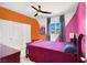 Colorful bedroom with accent walls, closet, window, and bed with nightstand at 3136 Mossfield Ave, Henderson, NV 89052