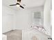 Bright bedroom with a ceiling fan, plush carpet, and a white bed frame with floral details at 3136 Mossfield Ave, Henderson, NV 89052