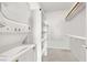Bright and airy closet equipped with a stackable washer and dryer and multiple shelves at 3136 Mossfield Ave, Henderson, NV 89052