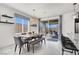 Dining area featuring modern table and bench seating with sliding glass doors leading to the outdoor patio at 3136 Mossfield Ave, Henderson, NV 89052
