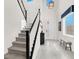 Inviting entryway with staircase, natural light from windows, and contemporary accents at 3136 Mossfield Ave, Henderson, NV 89052