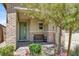 Welcoming front porch with brick accents and a cozy bench, complemented by lush landscaping at 3136 Mossfield Ave, Henderson, NV 89052