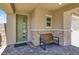 Inviting front porch with brick accents, a cozy bench, and a modern green door at 3136 Mossfield Ave, Henderson, NV 89052