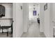 Hallway leads to an all-white bathroom with double vanity and tub at 3136 Mossfield Ave, Henderson, NV 89052