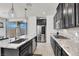 Modern kitchen features stainless steel appliances, granite countertops and dark cabinetry at 3136 Mossfield Ave, Henderson, NV 89052