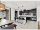 Stylish kitchen with island seating, pendant lighting, stainless appliances, and a dining area with backyard access at 3136 Mossfield Ave, Henderson, NV 89052