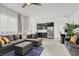 Open floor plan featuring a living room with a sectional sofa, that opens into a kitchen area at 3136 Mossfield Ave, Henderson, NV 89052