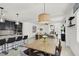 Open-concept kitchen and dining area flowing into a bright living space, perfect for entertaining guests at 3136 Mossfield Ave, Henderson, NV 89052