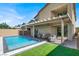 Exterior of a home featuring a swimming pool, covered patio, seating, and grass at 3136 Mossfield Ave, Henderson, NV 89052