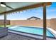 Backyard view of an inground swimming pool with a covered patio seating area at 3136 Mossfield Ave, Henderson, NV 89052