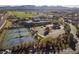 Stunning aerial view of community featuring tennis courts, pool, clubhouse, and golf course at 33 Desert Juniper Ln, Henderson, NV 89011