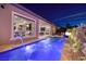 Luxury home with a sparkling backyard pool, water features, and manicured landscaping at 33 Desert Juniper Ln, Henderson, NV 89011